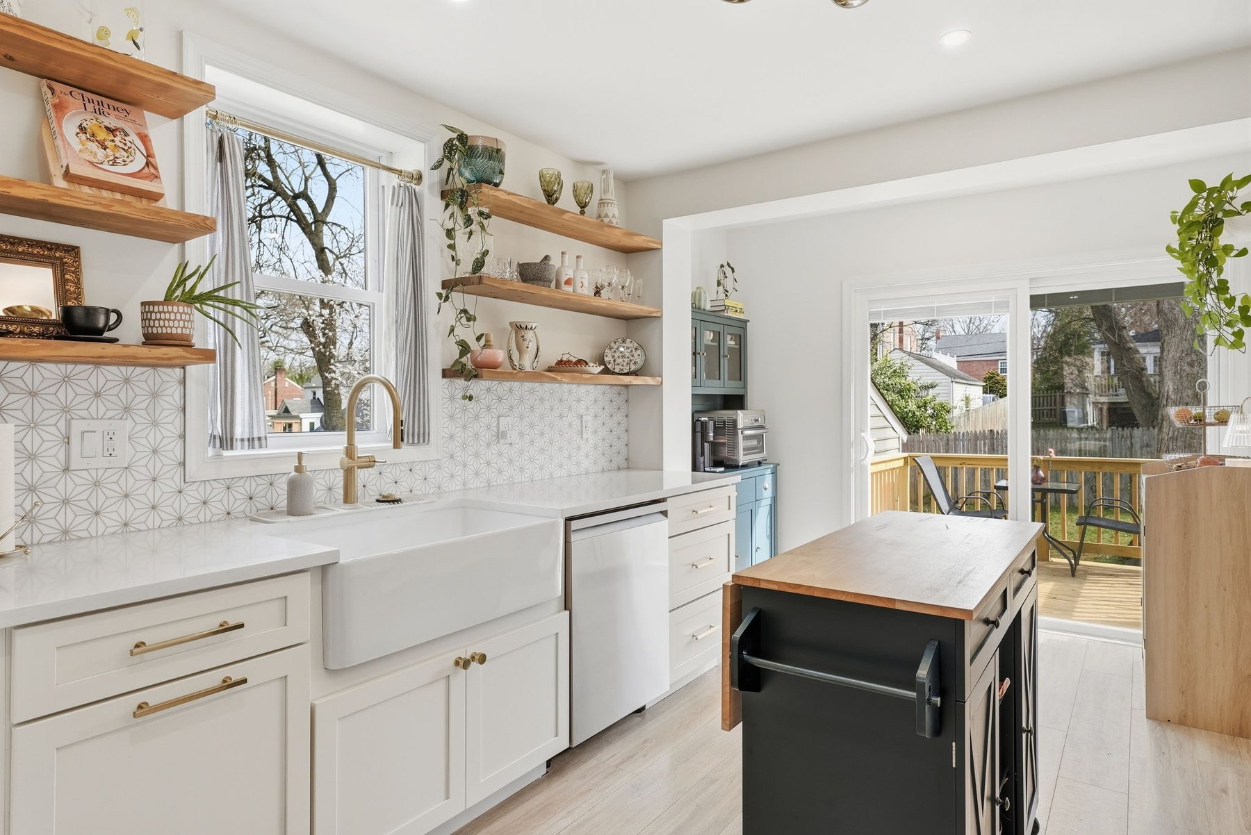 Bright renovated kitchen with wood shelving